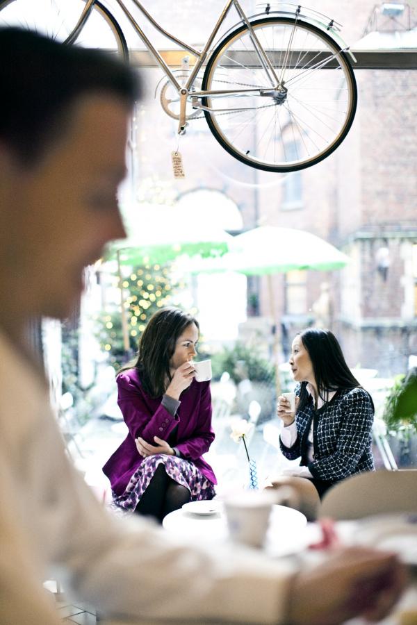 Women in meeting drinking coffee