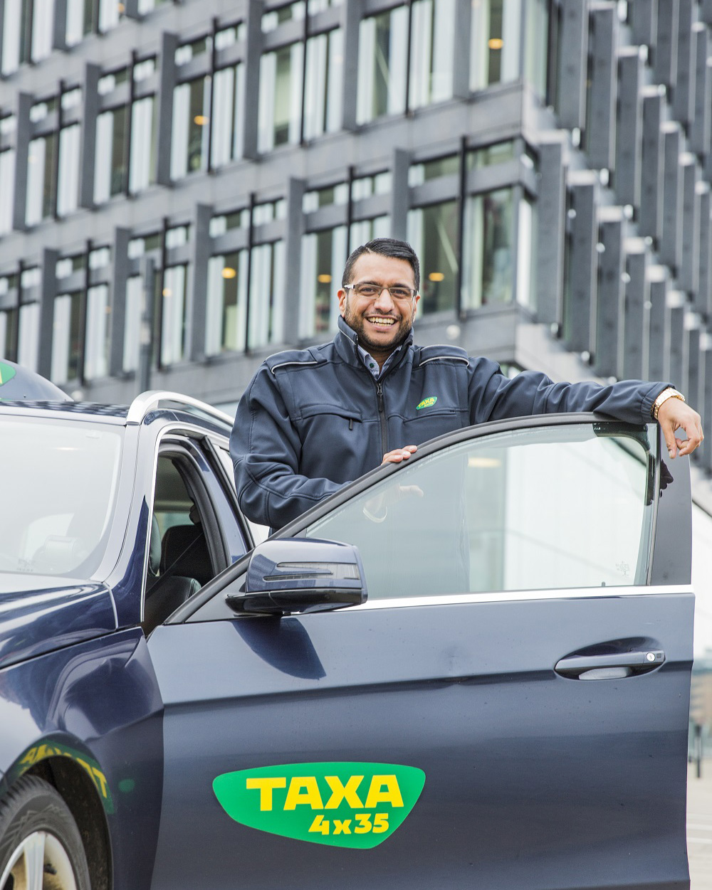 Taxa 4x35 driver standing with the car door open